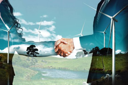 Photo for Double exposure graphic of business people handshake over wind turbine farm and green renewable energy worker interface. Concept of sustainability development by alternative energy. uds - Royalty Free Image
