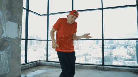 Photo for Motion shot of energetic caucasian hipster dance together near window sky scraper. Stylish energetic dancer pose while looking at camera. Outdoor sport 2024. Freestyle dancing. Endeavor. - Royalty Free Image