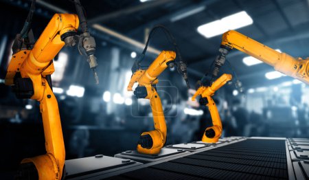 Foto de Brazo robot industrial mecanizado XAI para montaje en línea de producción de fábrica. Concepto de inteligencia artificial para la revolución industrial y el proceso de fabricación de automatización. - Imagen libre de derechos