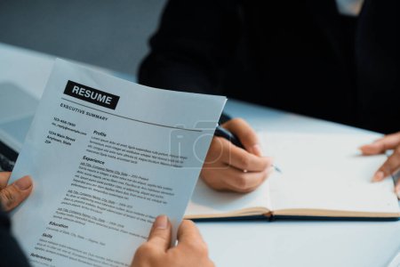 Photo for Human resources department manager reads CV resume document of an employee candidate at interview room. Job application, recruit and labor hiring concept. uds - Royalty Free Image