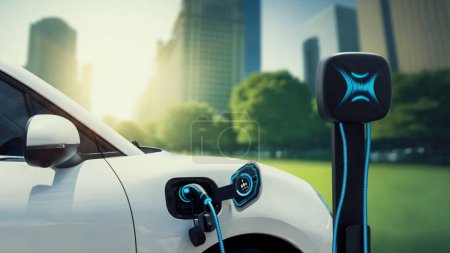 Photo for EV car plug in with charging station to recharge electricity from EV charger display battery status hologram in green park as futuristic eco lifestyle in city and utilization of clean energy. Peruse - Royalty Free Image