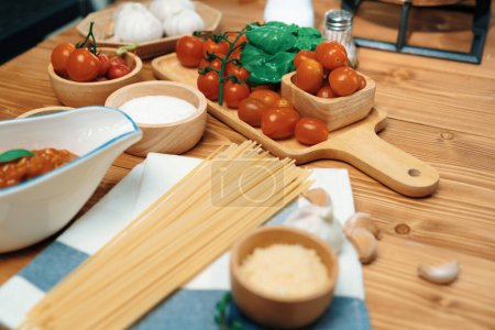Photo for Health foods recipe ingredients of special menu homemade cooking raw spaghetti with tomato sauce and basil of macro photo shooting placing elements on preparing wooden blurred background. Postulate. - Royalty Free Image