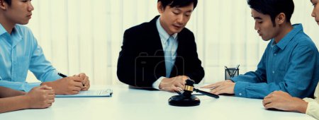 Photo for Lawyer acting as mediator broke a compromise between two parties to resolve business dispute through negotiation at law firm office. Legal mediation and conflict resolution service. Panorama Rigid - Royalty Free Image