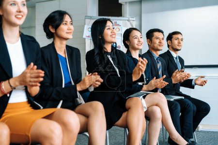 Photo for Professional young Asian and Caucasian audience applauding in group meeting presentation from partnership at office. Businessmen and businesswomen celebrating great success achievement. uds - Royalty Free Image