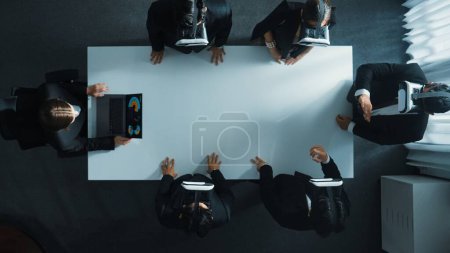 Photo for Top down aerial view of professional business team wear vr headset to enter virtual world while sitting and using hand gestures to manipulate the data from the manager laptop. Technology. Directorate. - Royalty Free Image