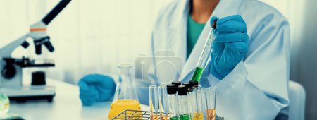Photo for Laboratory researcher develop new medicine or cure using chemical liquid in lab tube. Technological advance of healthcare with scientific expertise with laboratory equipment. Panorama Rigid - Royalty Free Image