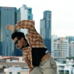 Hispanic break dancer practice B-boy footsteps at roof top with urban city view or sky scrapper. Young modern dancing group doing hip hop movement. Style,fashion,action. Outdoor sport 2024. Endeavor.