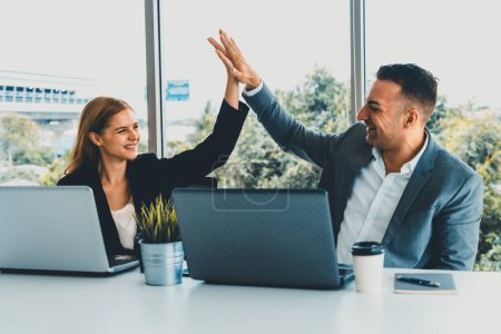 Photo for Success business partner - Businesswoman and businessman celebrating together in modern workplace office. People corporate teamwork concept. uds - Royalty Free Image
