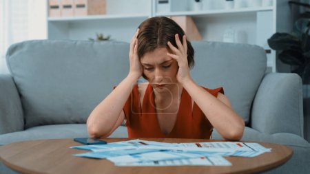 Photo for Stressed young woman has financial problems with credit card debt to pay prim from bad personal money and mortgage pay management crisis. Woman worry about financial bankruptcy risk from over spending - Royalty Free Image
