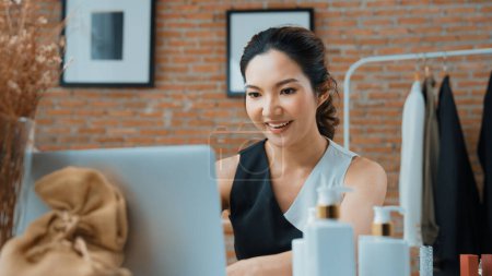 Photo for Woman influencer shoot live streaming vlog video review skincare for social media or blog. Happy young girl with vivancy cosmetics studio lighting for marketing recording session broadcasting online. - Royalty Free Image