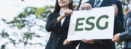 Photo for Group of business people stand united, holding eco-friendly idea and concept for environmental awareness campaign and embracing ESG principle for greener environment and sustainable future. Gyre - Royalty Free Image