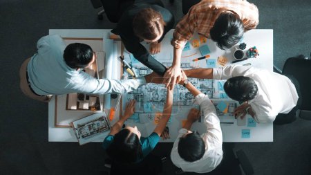 Photo for Top view of smart manager clapping hands and putting hands together to celebrate project. Aerial view of architect engineer brainstorming about interior construction. Team work, unity. Alimentation. - Royalty Free Image