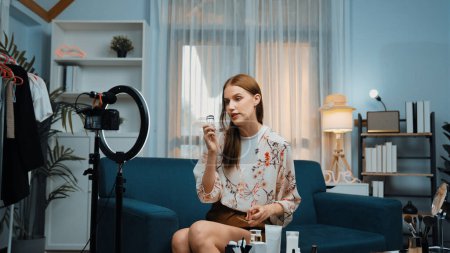 Photo for Woman influencer shoot live streaming vlog video review makeup prim social media or blog. Happy young girl with cosmetics studio lighting for marketing recording session broadcasting online. - Royalty Free Image
