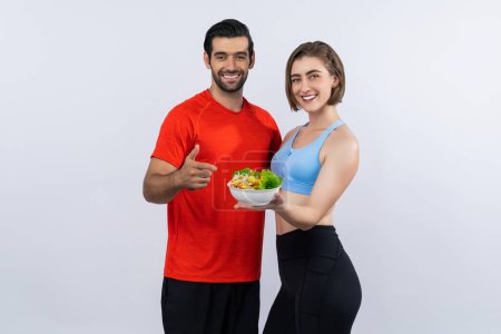 Photo for Full body length gaiety shot athletic and sporty young couple with healthy vegan food in standing posture on isolated background. Healthy active and body care by vegetarian lifestyle. - Royalty Free Image