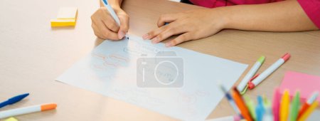 Photo for Professional businesswoman drawing business mind map. Creative female startup leader drafts marketing plans using pens and sticky notes to brainstorms idea. Closeup. Focus on hand. Variegated. - Royalty Free Image