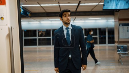 Photo for Handsome business man standing or walking while train gate opened. Professional project manager standing at train station while going to work place. Blurred background. Public transport. Exultant. - Royalty Free Image