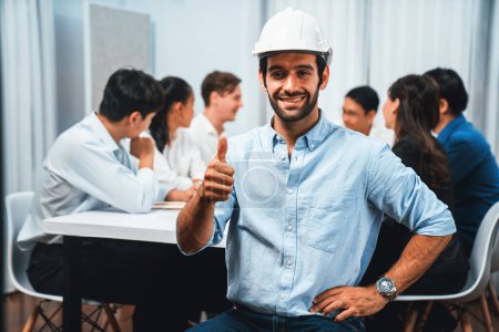Photo for Engineer team leader portrait with diverse group of civil engineer and client working together on architectural project, reviewing construction plan and building blueprint at meeting table. Prudent - Royalty Free Image