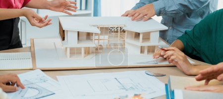 Photo for Professional architect team discussing about house design and appropriate interior materials. Cropped image of interior designers brainstorming about interior materials at meeting room. Variegated. - Royalty Free Image