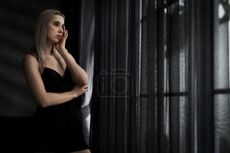Photo for Young woman with critical depression and anxiety disorder from loneliness, mental sickness, or unwanted pregnancy, feeling lifeless on dark bedroom. Overwhelming negative thought and reclusive. Blithe - Royalty Free Image