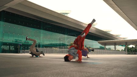 Photo for Group of happy hipster or street dancer doing freeze pose in front of mall. Funny energetic break dancer practice b-boy step dancing with friends. Outdoor sport 2024. Street dancer concept. Sprightly. - Royalty Free Image