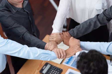Photo for Diverse team of officer workers hold hands in circle, showing solidarity and teamwork in corporate office. Businesspeople form strong community built on integrity and collaboration. Concord - Royalty Free Image
