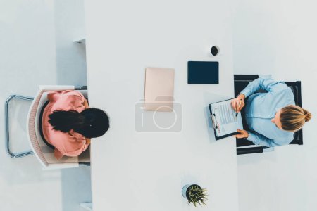 Photo for Two young business women in meeting at office table for job application and business agreement. Recruitment and human resources concept. uds - Royalty Free Image