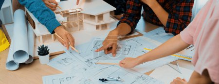 Photo for Skilled architect engineer team meeting pointing at blueprint while professional interior designer analysis and brainstorming about house structure. Creative design and teamwork concept. Burgeoning. - Royalty Free Image
