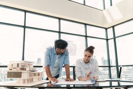 Photo for Professional diverse architect engineer team working together to design house model. Group of successful business team discussing and brainstorming about house structure. Civil engineering. Tracery. - Royalty Free Image