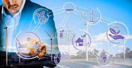 Photo for Double exposure graphic of business people working over wind turbine farm and green renewable energy worker interface. Concept of sustainability development by alternative energy. uds - Royalty Free Image