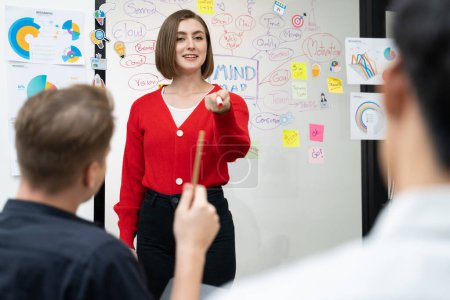 Photo for Closeup image of male project manager raise hand to ask questions while young beautiful leader presents business project with confident by using mind map and colorful sticky notes. Immaculate. - Royalty Free Image