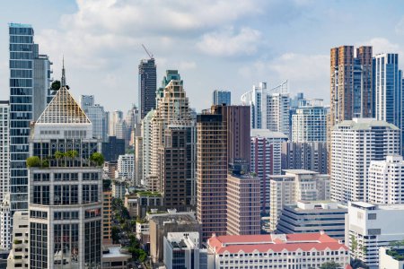 Téléchargez les photos : Image rapprochée du paysage urbain de Bangkok. Paysage urbain moderne entouré d'un bâtiment architectural avec lumière du jour et ciel bleu. Vue latérale. Contexte commercial. Lumière du jour. Orné. - en image libre de droit