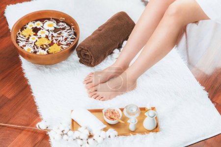 Panorama top view woman indulges in blissful foot massage at luxurious spa salon while masseur give reflexology therapy in gentle day light ambiance resort or hotel foot spa. Quiescent