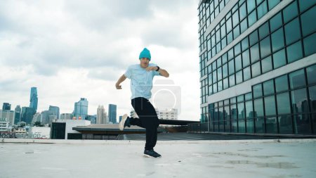 Photo for Stylish caucasian dancing man performing break dance at skyscraper. Portrait image of young happy man practicing street dance performance choreographer in modern urban city. Paris style. Endeavor. - Royalty Free Image
