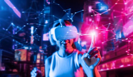 Foto de Blur of smart female stand in cyberpunk style building in meta wear VR headset connecting metaverse, future cyberspace community technology, Woman use index finger touch virtual object. Alucinaciones. - Imagen libre de derechos