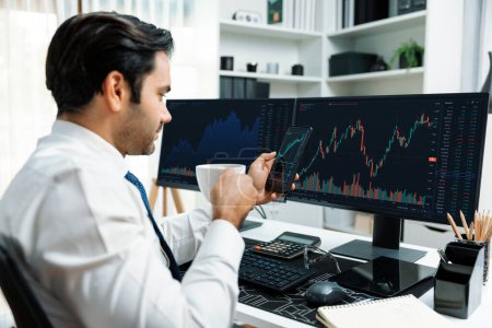 Trader businessman holding coffee cup focusing on dynamic on phone, stock exchange investment screen comparing data analysis to invest high profit financial technology market at home office. Surmise.