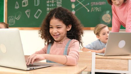 Photo for Attractive girl coding prompt while looking at camera at STEM class while happy teacher checking smart boy software program. Diverse student study about programing code and computing system. Pedagogy. - Royalty Free Image