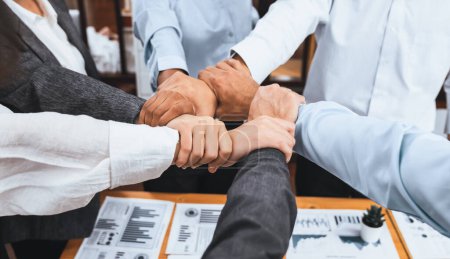 Photo for Diverse team of officer workers hold hands in circle, showing solidarity and teamwork in corporate office. Businesspeople form strong community built on integrity and collaboration. Concord - Royalty Free Image