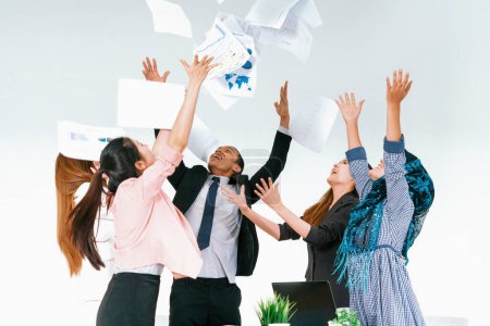 Photo for Smiling business people having fun by throwing papers in the air celebrating business success in the modern office. Happy workplace and casual career company concept. uds - Royalty Free Image