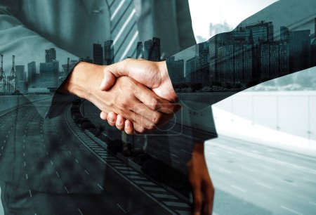 Photo for Double exposure image of business people handshake on city office building in background show partnership success of business deal. Concept of corporate teamwork, trust partner and work agreement. uds - Royalty Free Image