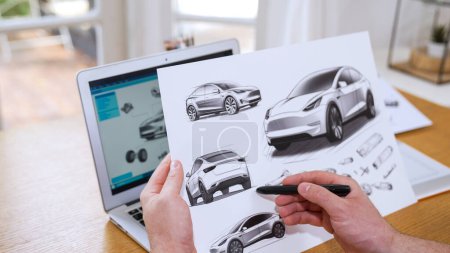 Photo for Car design engineer analyze car prototype for automobile business at home office. Automotive engineering designer carefully analyze, finding flaws and improvement for car design with laptop Synchronos - Royalty Free Image