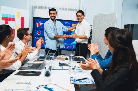 Photo for Analyst team leader shake hand with his colleague after successful data analysis meeting using FIntech software power with business intelligence or BI dashboard. Prudent - Royalty Free Image