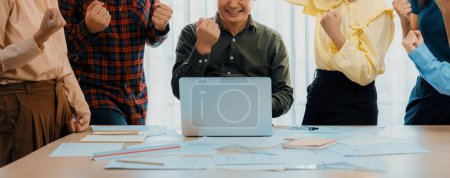 Photo for Happy professional business team celebrate their success project at modern meeting room on table with business document scattered. Manager and coworker happy because of increasing sales. Delineation. - Royalty Free Image