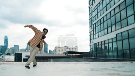 Photo for Happy hispanic dancer wears casual outfit break dancing at urban city. Energetic hip-hop performance. Choreographer move along the freestyle beat. Hip hop dancing. Outdoor sport 2024. Endeavor. - Royalty Free Image