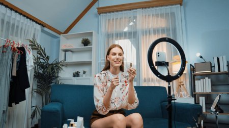 Photo for Woman influencer shoot live streaming vlog video review makeup prim social media or blog. Happy young girl with cosmetics studio lighting for marketing recording session broadcasting online. - Royalty Free Image
