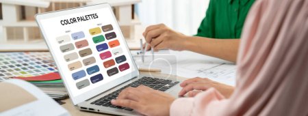 Photo for Skilled interior designer using architectural equipment draw a blueprint while interior designer select appropriate color carefully by using laptop. Creative design and teamwork concept. Variegated. - Royalty Free Image