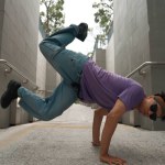 Professional break dancer perform street dance at narrow corridor. Skilled happy asian hipster moving to music while show b-boy step at narrow wall. Modern lifestyle. Outdoor sport 2024. Sprightly.