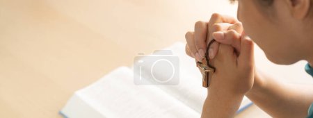 Photo for Female folded hand prayed on holy bible book faithfully at wooden church. Concept of hope, religion, faith, christianity, catholic, believe and god blessing. Warm and brown background. Burgeoning. - Royalty Free Image