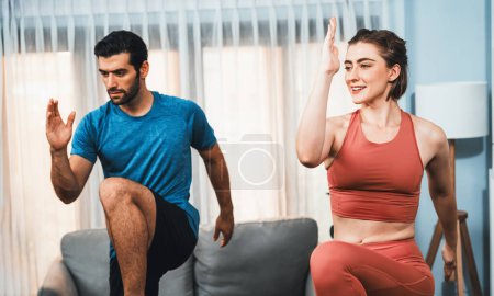 Photo for Athletic and sporty fitness couple or exercise buddy running posture at home body workout exercise session for fit physique and healthy sport lifestyle at home. Gaiety home exercise workout training. - Royalty Free Image
