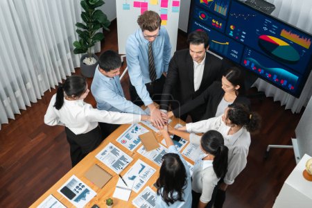 Photo for Multiracial business people make synergy hand stack together in meeting room as cooperation or team building for corporate employee in workplace. Habiliment - Royalty Free Image