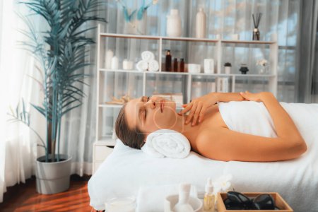 Photo for Caucasian woman customer enjoying relaxing anti-stress spa massage and pampering with beauty skin recreation leisure in day light ambient salon spa at luxury resort or hotel. Quiescent - Royalty Free Image